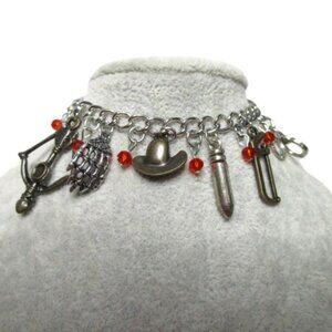 VINTAGE CHARM BRACELET WITH WEAPON TYPE CHARMS.